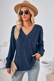 Button-cuff slouch v-neck top in Dusty Blue with button details on sleeves.