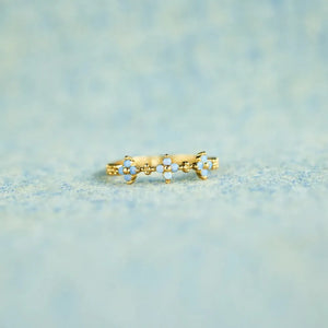 Gold celestial blossom band ring with blue stone accents