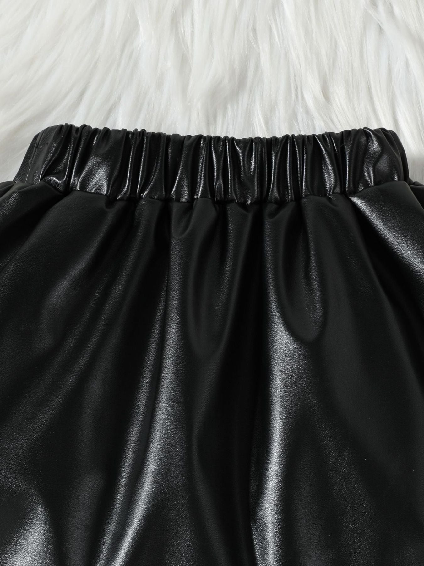 Black faux leather toddler shorts with elastic waistband detail