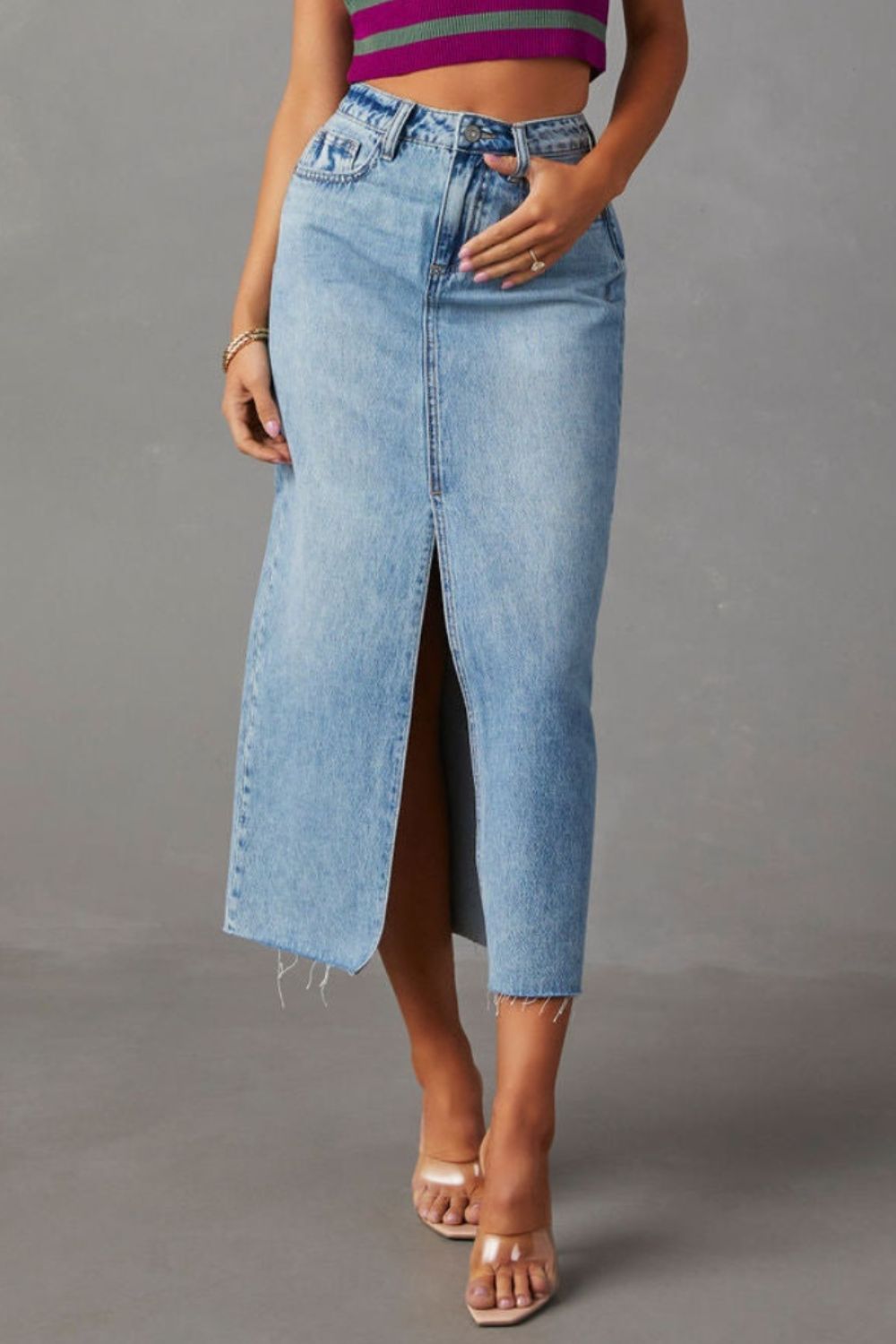 Light blue denim midi skirt with raw hem and front slit