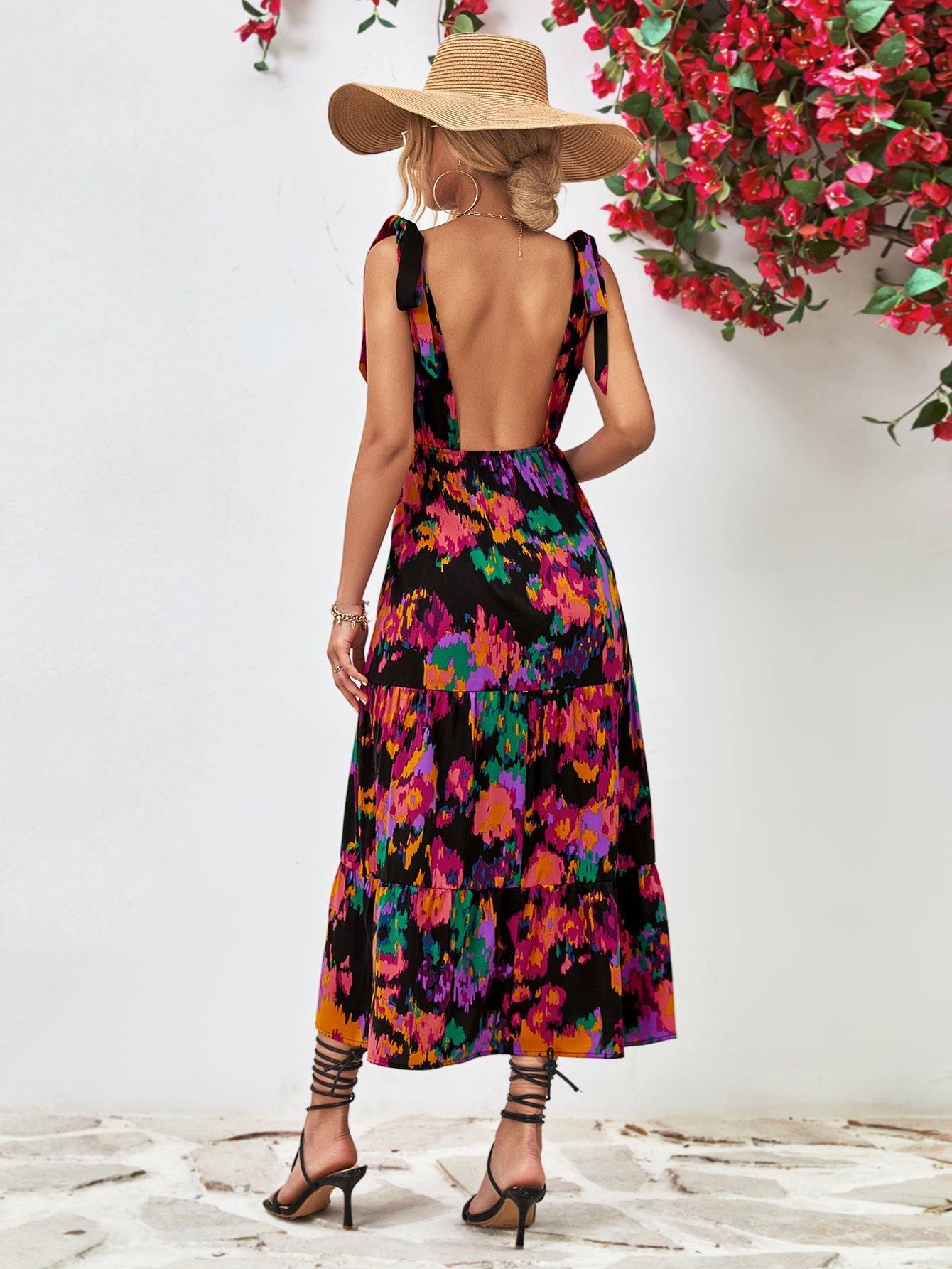 Maxi dress with abstract print, tie straps, and tiered skirt.