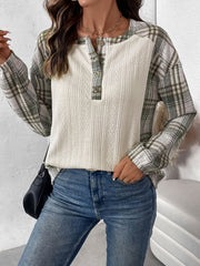 Cream textured henley top with plaid raglan sleeves and button detail.