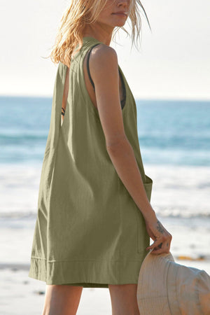 Relaxed fit linen romper in Matcha Green with pockets and a cutout back detail.