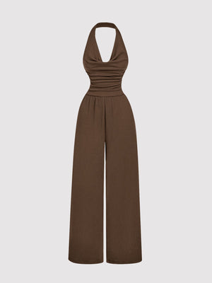 Brown halter neck wide-leg romper with ruched bodice and elastic waist