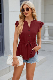Burgundy textured eyelet peplum blouse with tie waist and flutter sleeves.