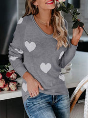 Gray raglan knit sweater with white heart motif, v-neck, long sleeves.