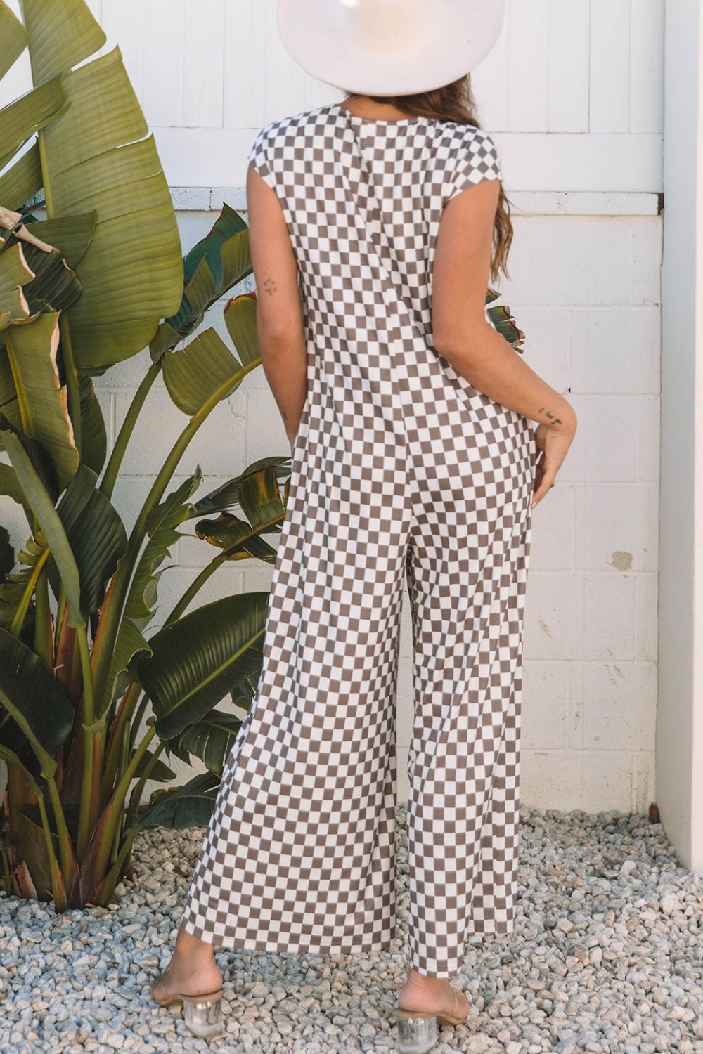 Checkered palazzo jumpsuit in mocha with cap sleeves and wide legs.