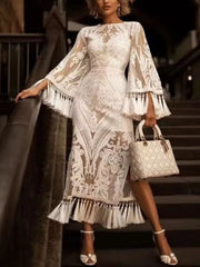 White lace midi dress with bell sleeves, tassel hem, and ornate pattern.