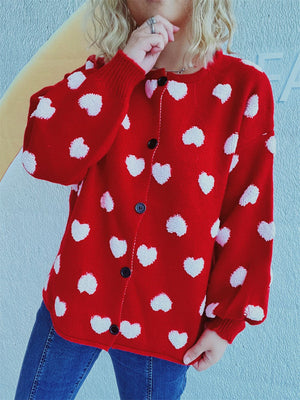 Deep Red acrylic button-down cardigan with textured white heart motif and black buttons.