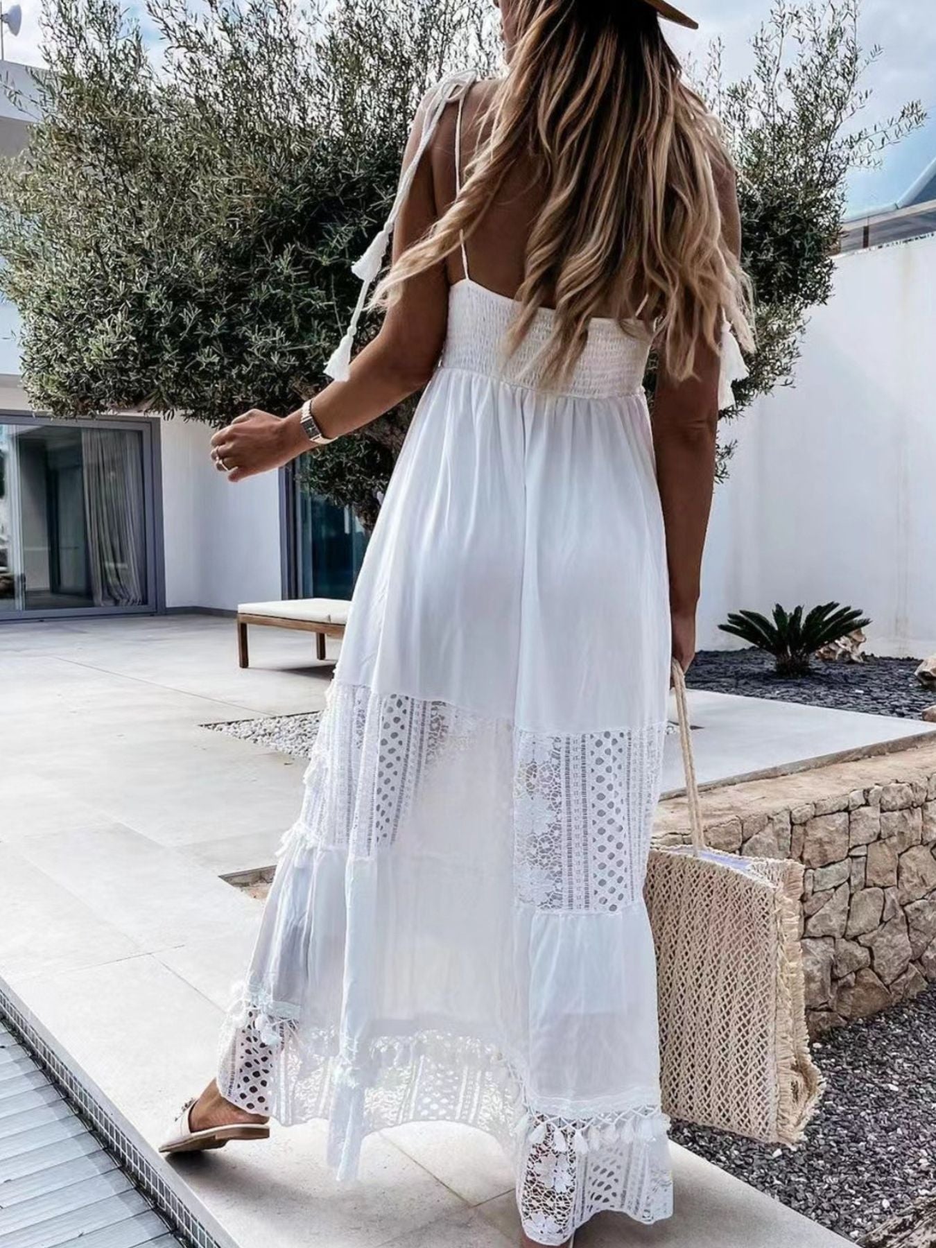 White crochet cami maxi dress with tiered lace panels and tassels.