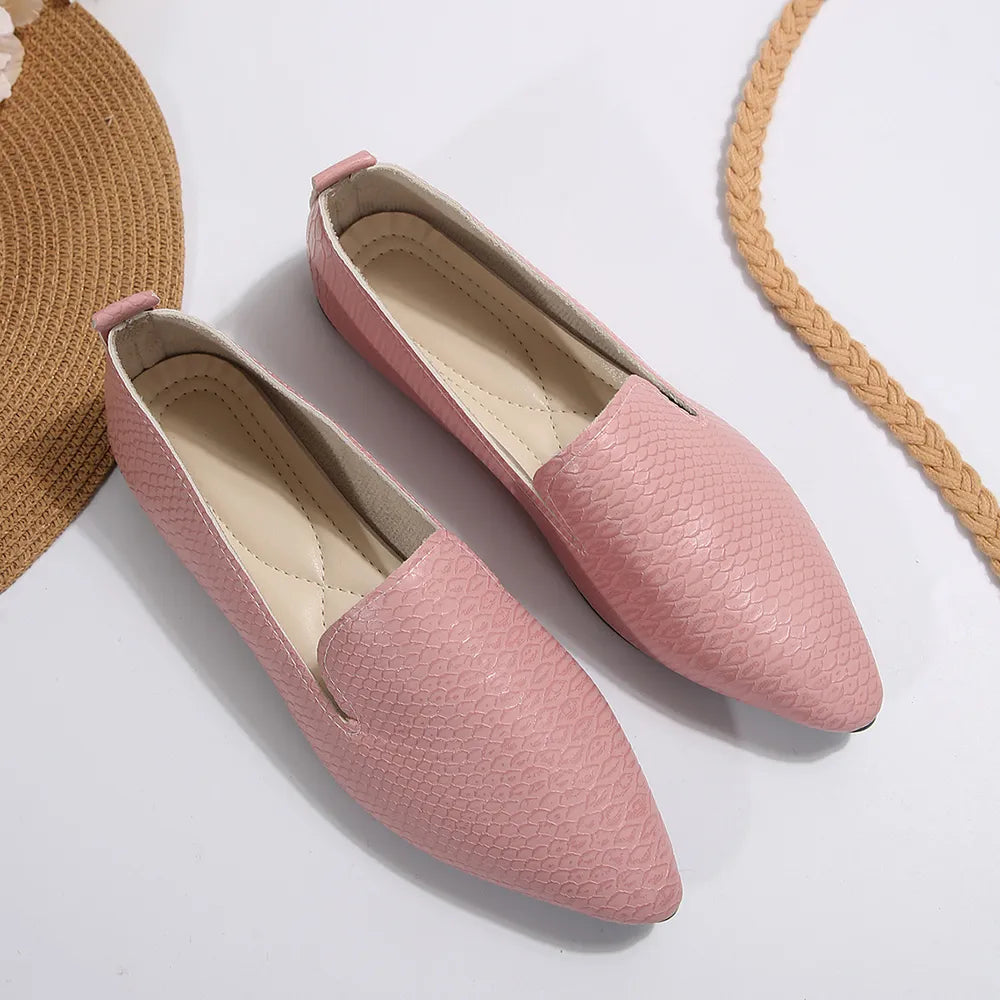 Textured dusty pink pointed-toe slip-on loafers with a subtle snakeskin pattern.