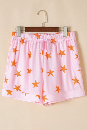 Blush pink pajama shorts with orange stars, elastic waist, and drawstring.