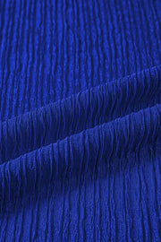 Blue textured polyester shirt with short sleeves and ruffle trim detail.