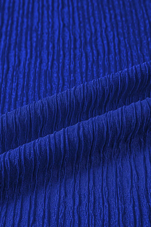 Blue textured polyester shirt with short sleeves and ruffle trim detail.