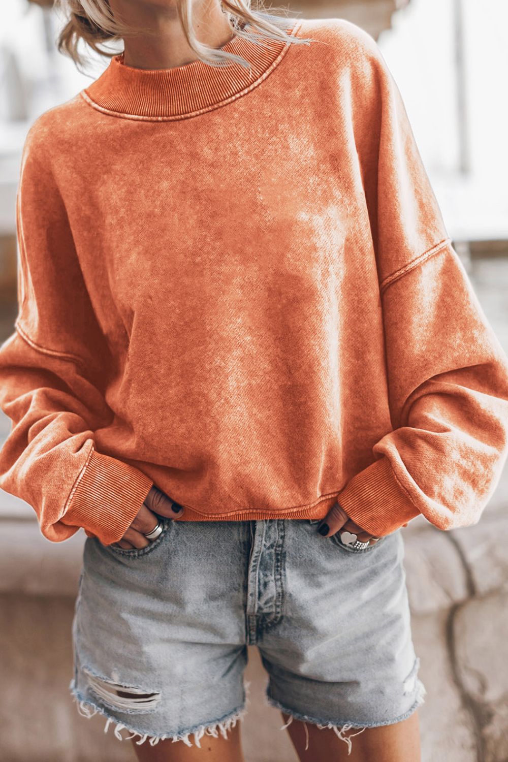 Acid wash mock neck sweatshirt in Sherbet with ribbed cuffs and neckline.