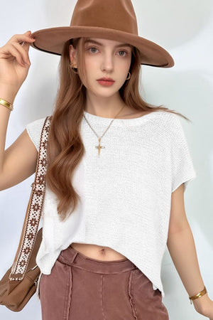White boxy knit crop top with short sleeves and a boat neck.