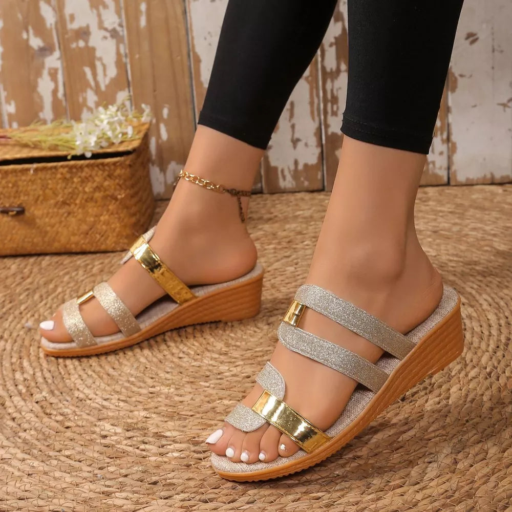 Glistening dual-strap wedge sandals in gold and silver with a comfortable wedge heel.