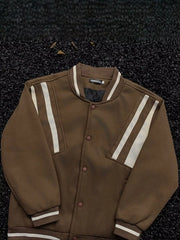 Brown bomber jacket with white stripe details on sleeves and collar, buttoned front.