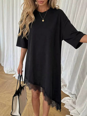 Black asymmetrical t-shirt dress with lace trim hem and short sleeves.