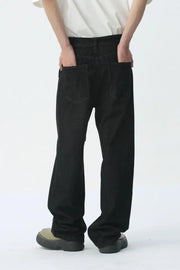 Black wide-leg denim jeans with belt detail and back pockets.