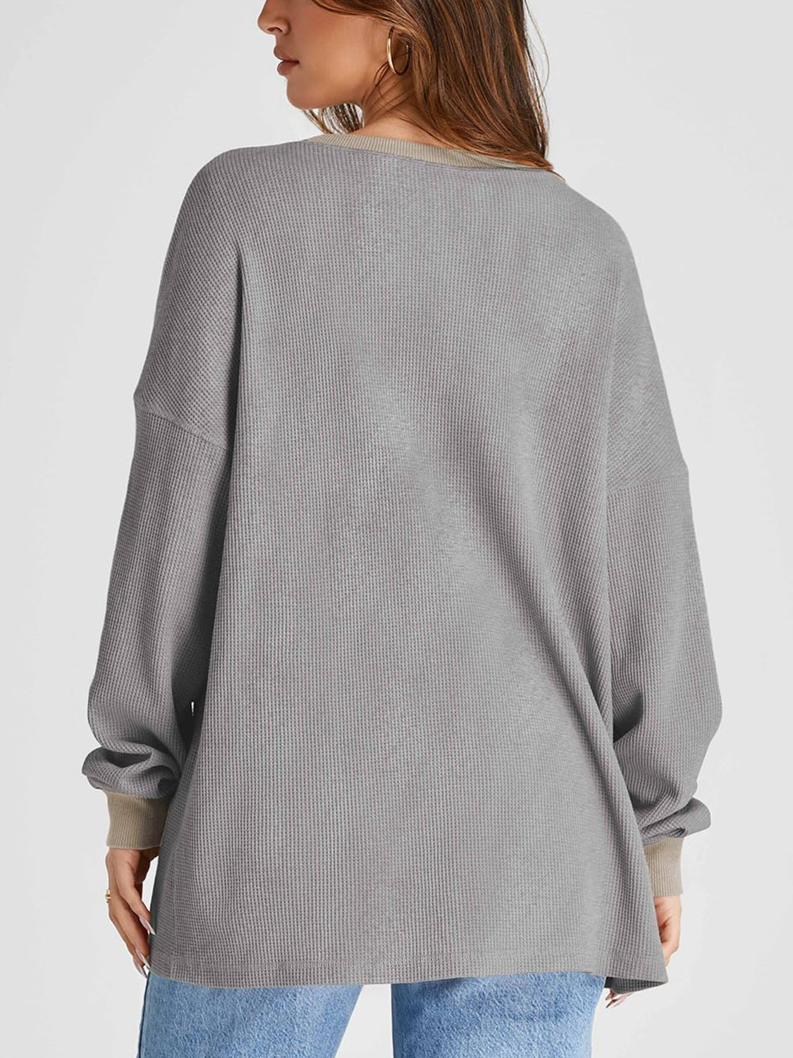 Gray waffle knit raglan sleeve sweatshirt with tan cuffs and neckline detail.