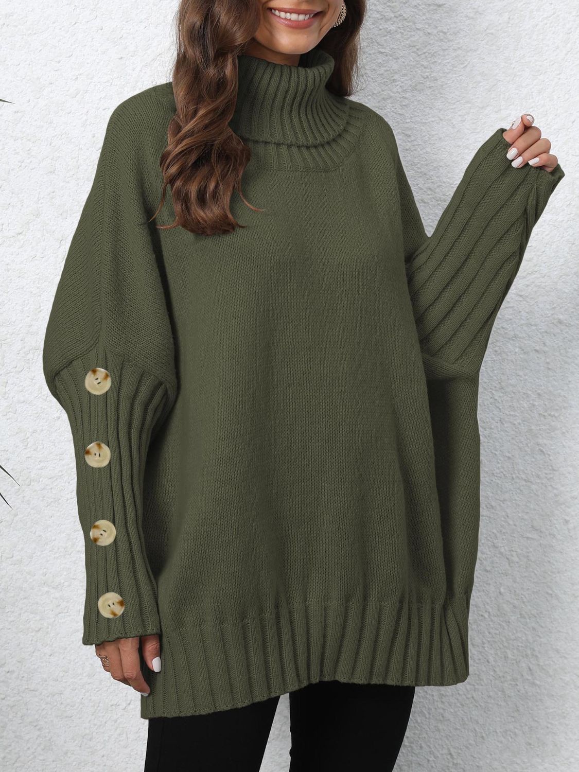Button-cuff turtleneck sweater in olive green knit with ribbed sleeves and button detail.