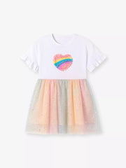 White baby dress with rainbow heart applique and glittery pastel tulle skirt.