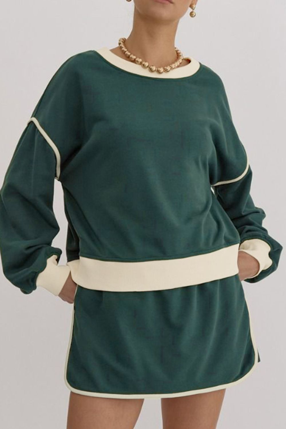 Dark green sweatshirt and skort set with cream contrast trim and neckline.