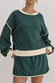 Dark green sweatshirt and skort set with cream contrast trim and neckline.