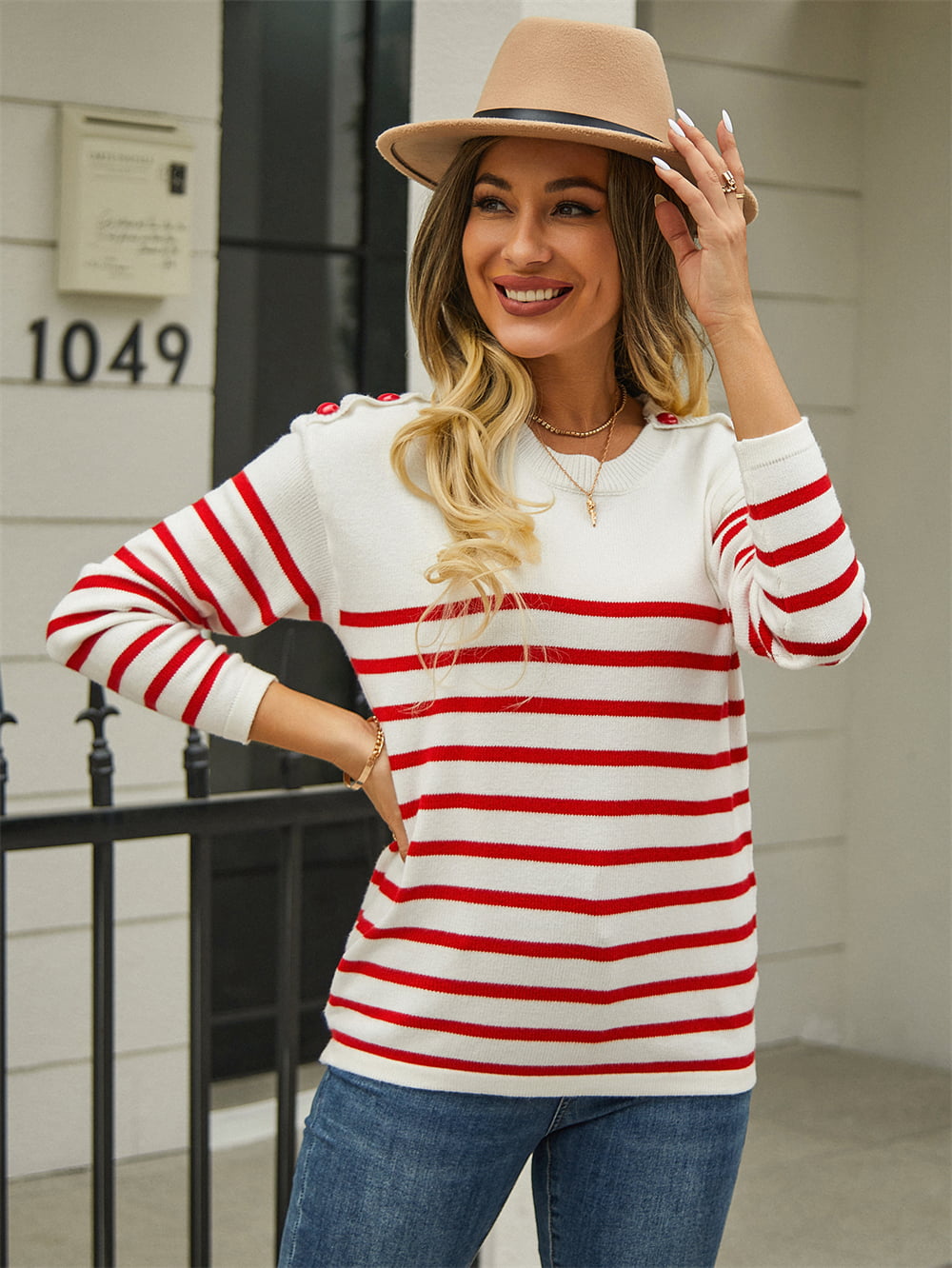 White and red striped acrylic sweater with shoulder buttons.