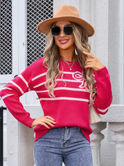 Watermelon pink striped knit pullover sweater with white stripes and a bow detail.