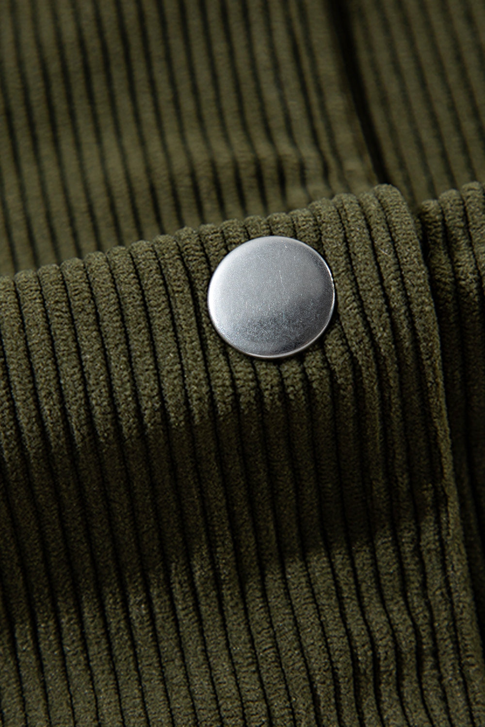 Moss corduroy bomber jacket detail with silver snap button.