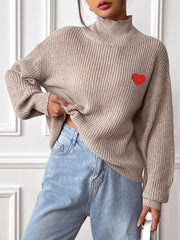Khaki mock neck knit sweater with red heart appliqué and ribbed texture.