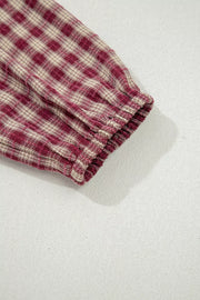 Country plaid long sleeve blouse in burgundy with elastic cuff detail.