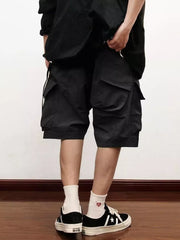 Black relaxed fit cargo shorts with multiple pockets and drawstring waist.