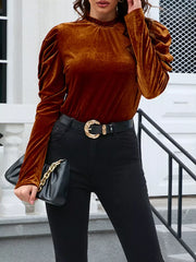 Brown velvet mock neck blouse with ruffled neckline and puffed sleeves.