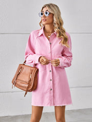 Pink denim shirt dress with raw hem, button front, and chest pockets.