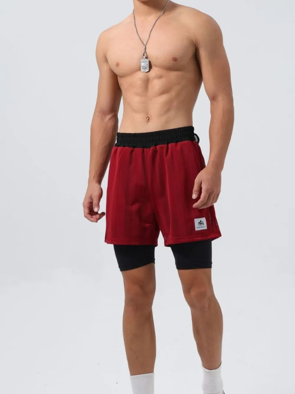 Burgundy layered mesh performance shorts with black compression liner and black waistband.