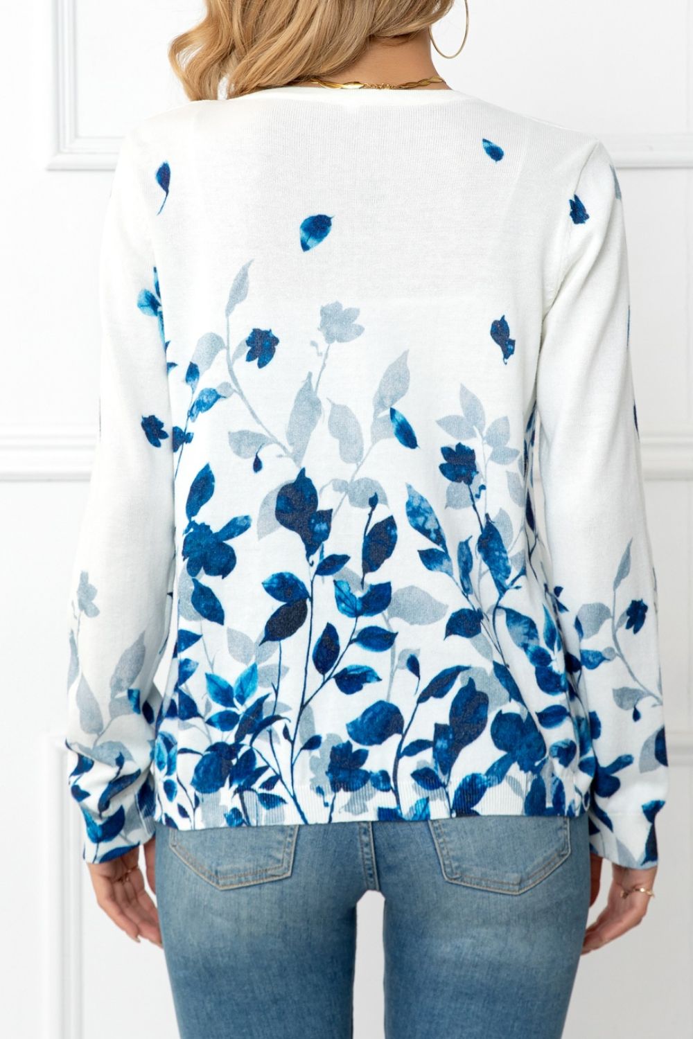White crewneck cardigan with blue botanical print and long sleeves