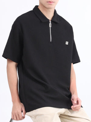 Black textured polo shirt with short sleeves and a zipper detail