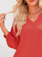 Red polyester blouse with smocked cuffs and V-neck