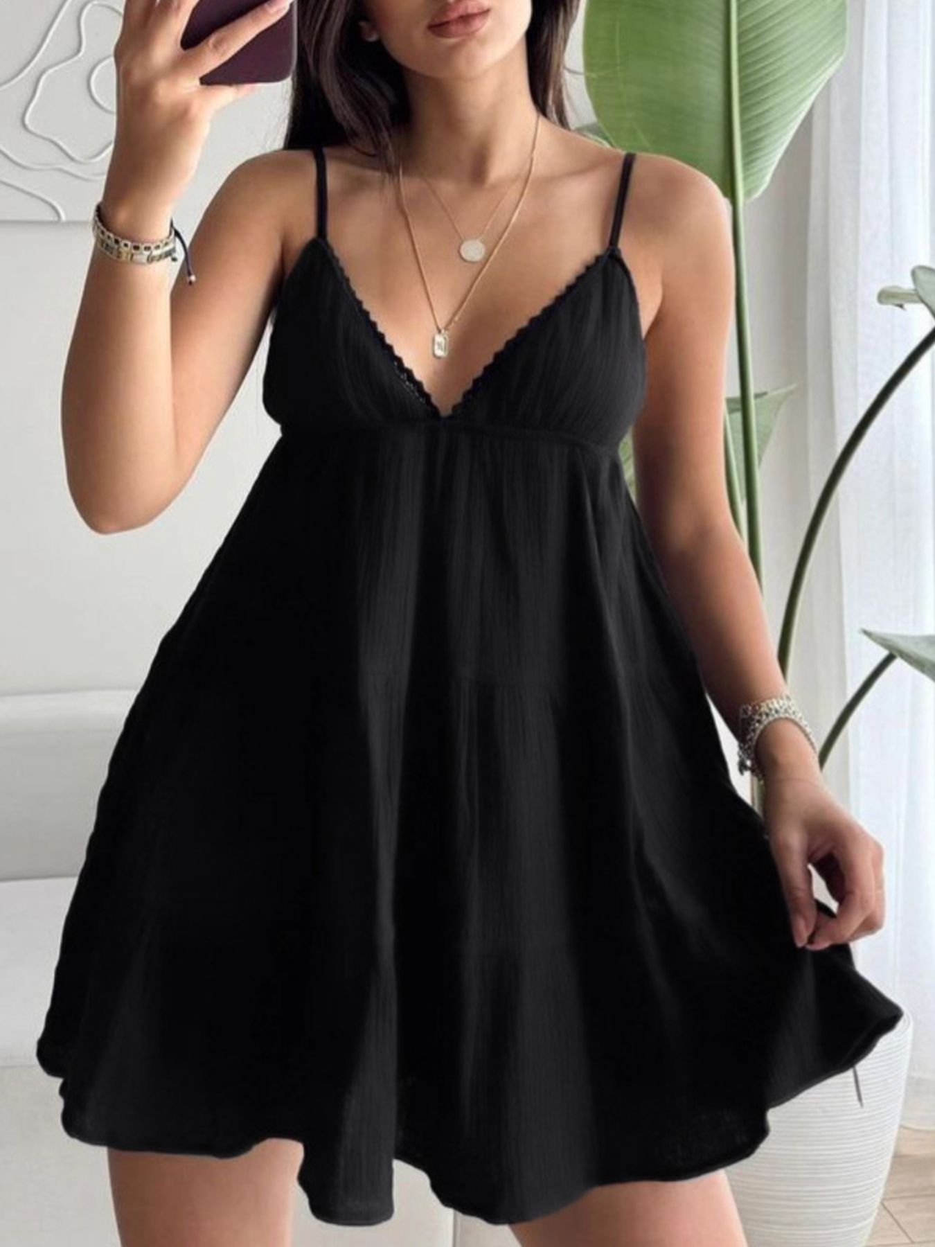 Black cotton tiered mini dress with lace trim V-neck and spaghetti straps