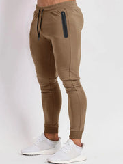 Camel slim fit tech joggers with zip pocket and drawstring.