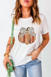 White t-shirt with a striped pumpkin graphic and a black and white polka dot bow detail.