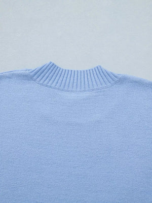 Light blue ribbed knit top with ruffled round neck detail