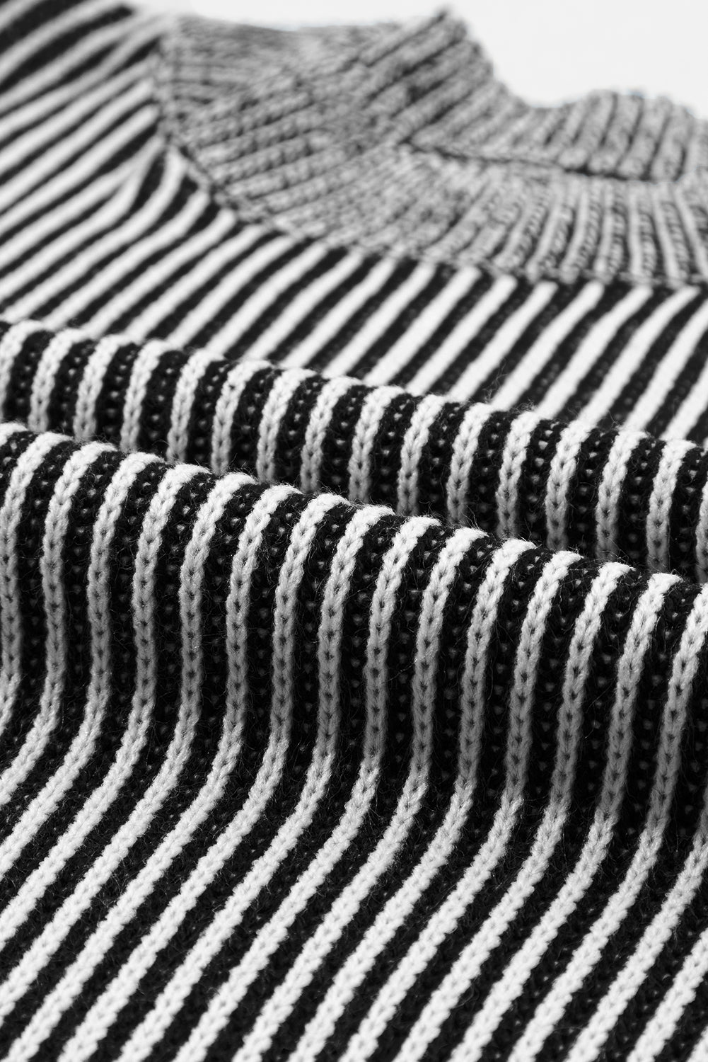 Black and white striped acrylic mock neck pullover sweater with vertical ribbing detail.