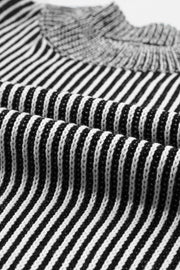 Black and white striped acrylic mock neck pullover sweater with vertical ribbing detail.