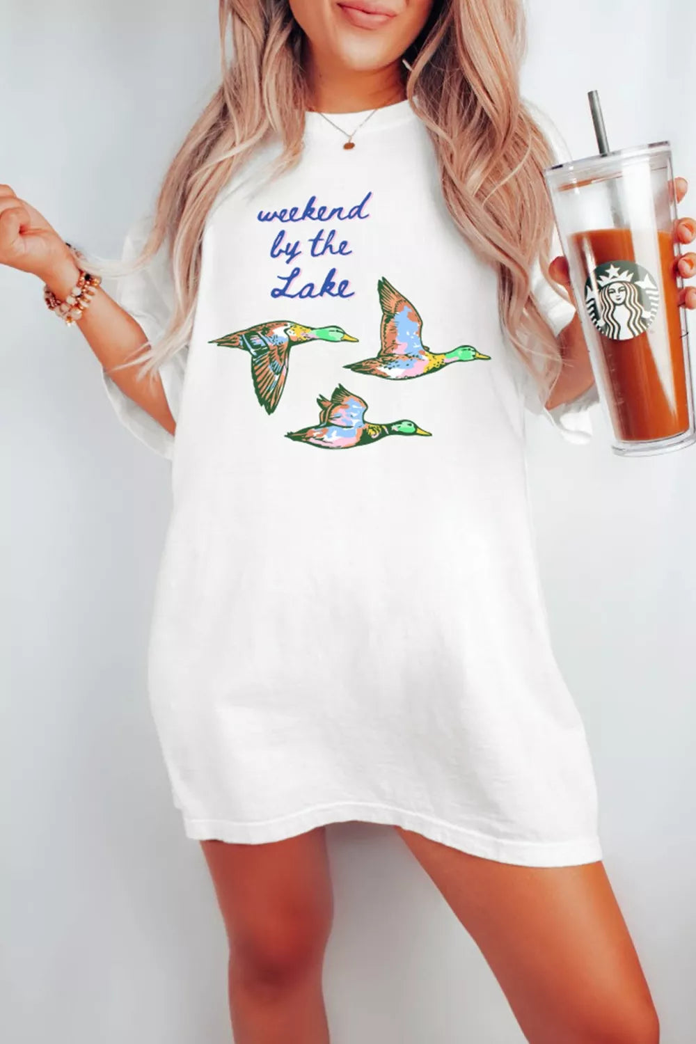 White cotton oversized tee with graphic ducks and text print.