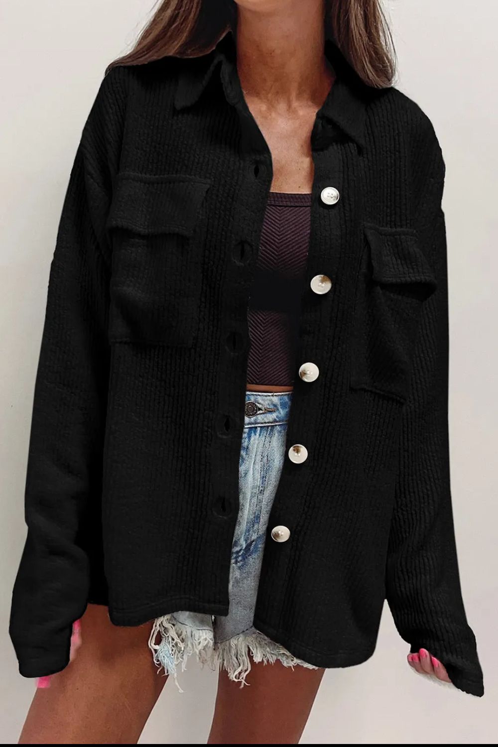 Black textured corduroy overshirt with patch pockets and button front.