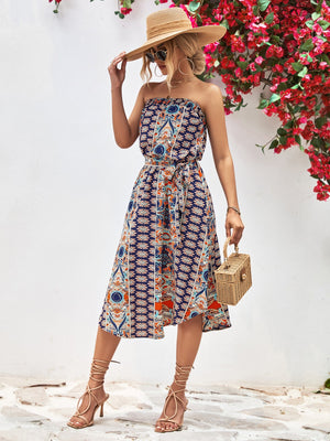 Printed bandeau midi dress with asymmetric hem and belt in dark blue.